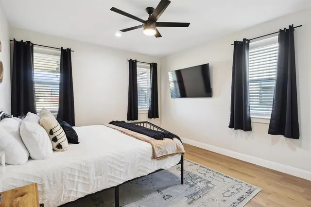 a bedroom with a bed and a flat screen tv