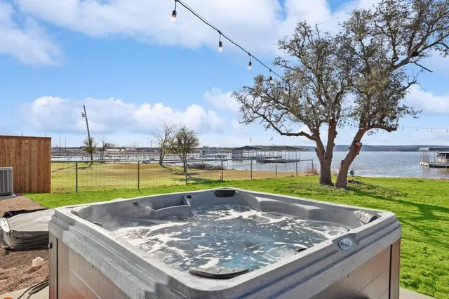 a view of swimming pool with a yard and large trees