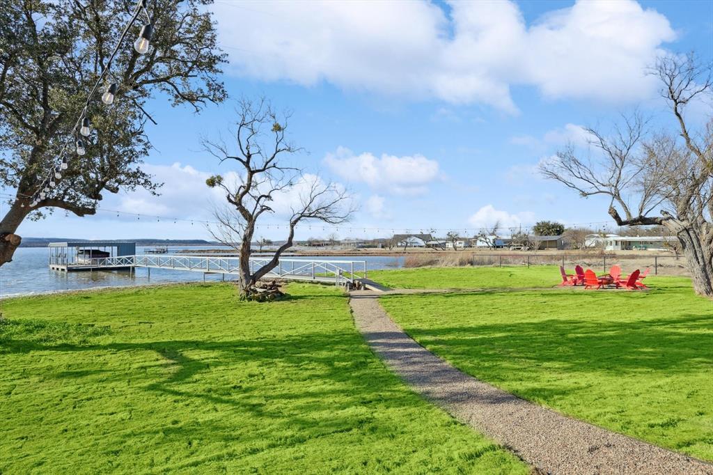 413 Hoot Avenue Graford, TX 76449 - Photo 34 of 38 a view of a big yard with potted plants and large trees