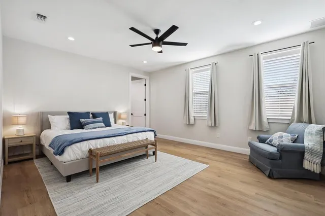 a spacious bedroom with a bed and a couch