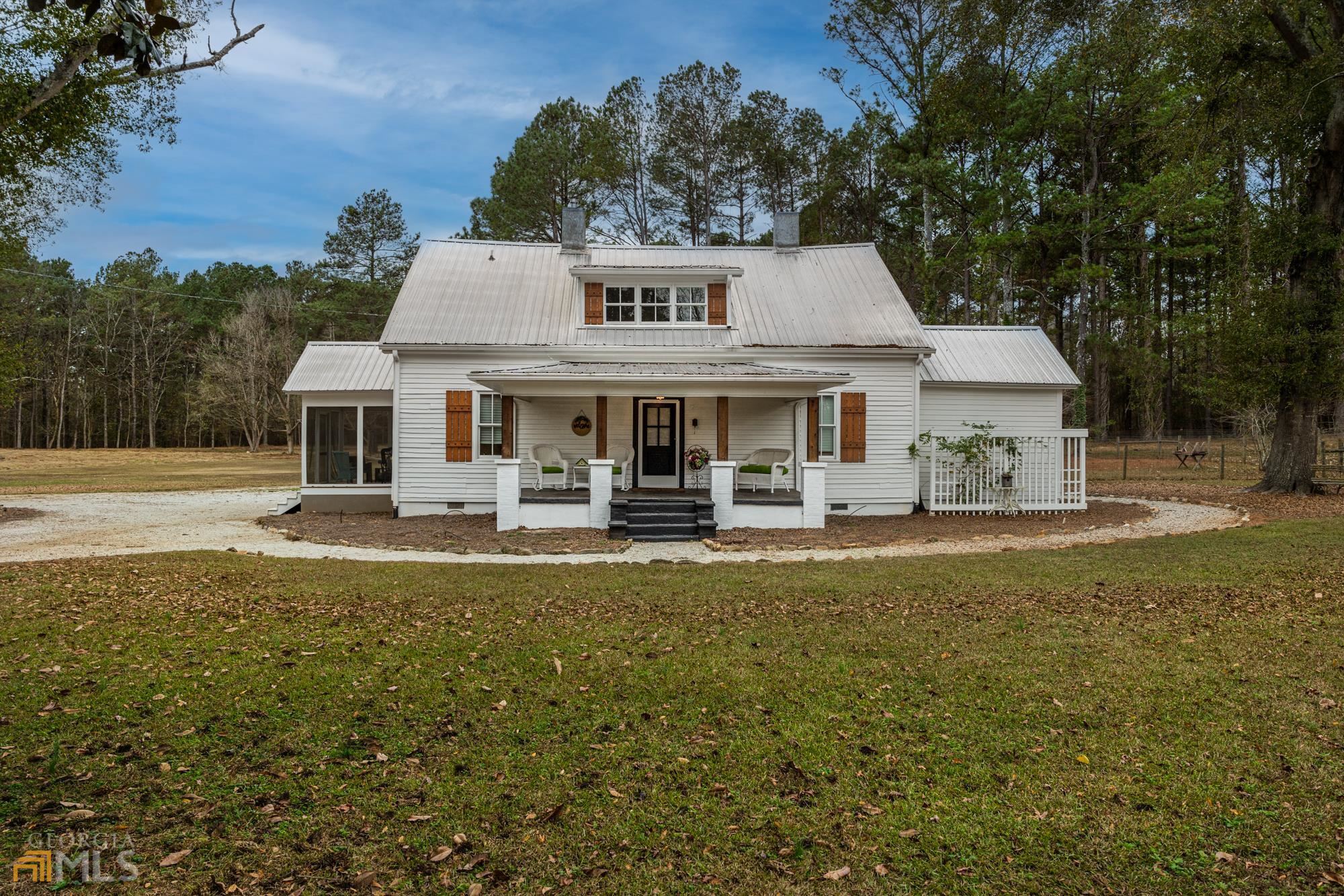 2451 Pierce Dairy Road Madison, GA 30650 - Photo 1 of 1 a front view of a house with garden
