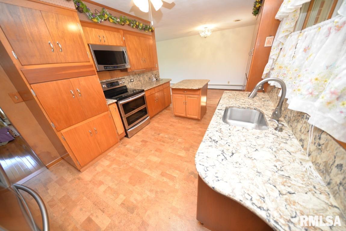 11455 East Richview Road Mount Vernon, IL 62864 - Photo 22 of 37 a kitchen with stainless steel appliances kitchen island granite countertop a sink stove and granite countertops