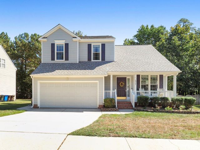 a front view of a house with a yard and garage