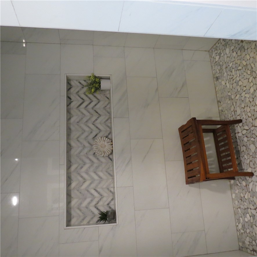 10160 Lochard Road Sidney, OH 45365 - Photo 23 of 41 This sleek shower showcases modern tilework, offering a serene and clean aesthetic.