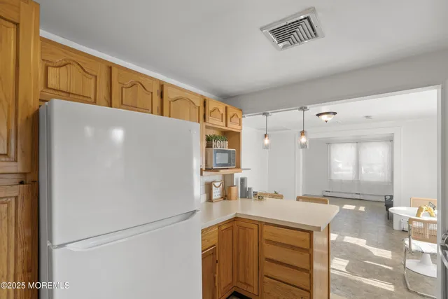 a kitchen with a refrigerator a sink and cabinets