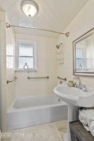 a bathroom with a bathtub and a sink
