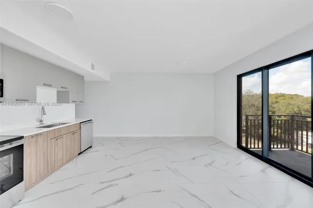 a view of a kitchen with furniture and staircase