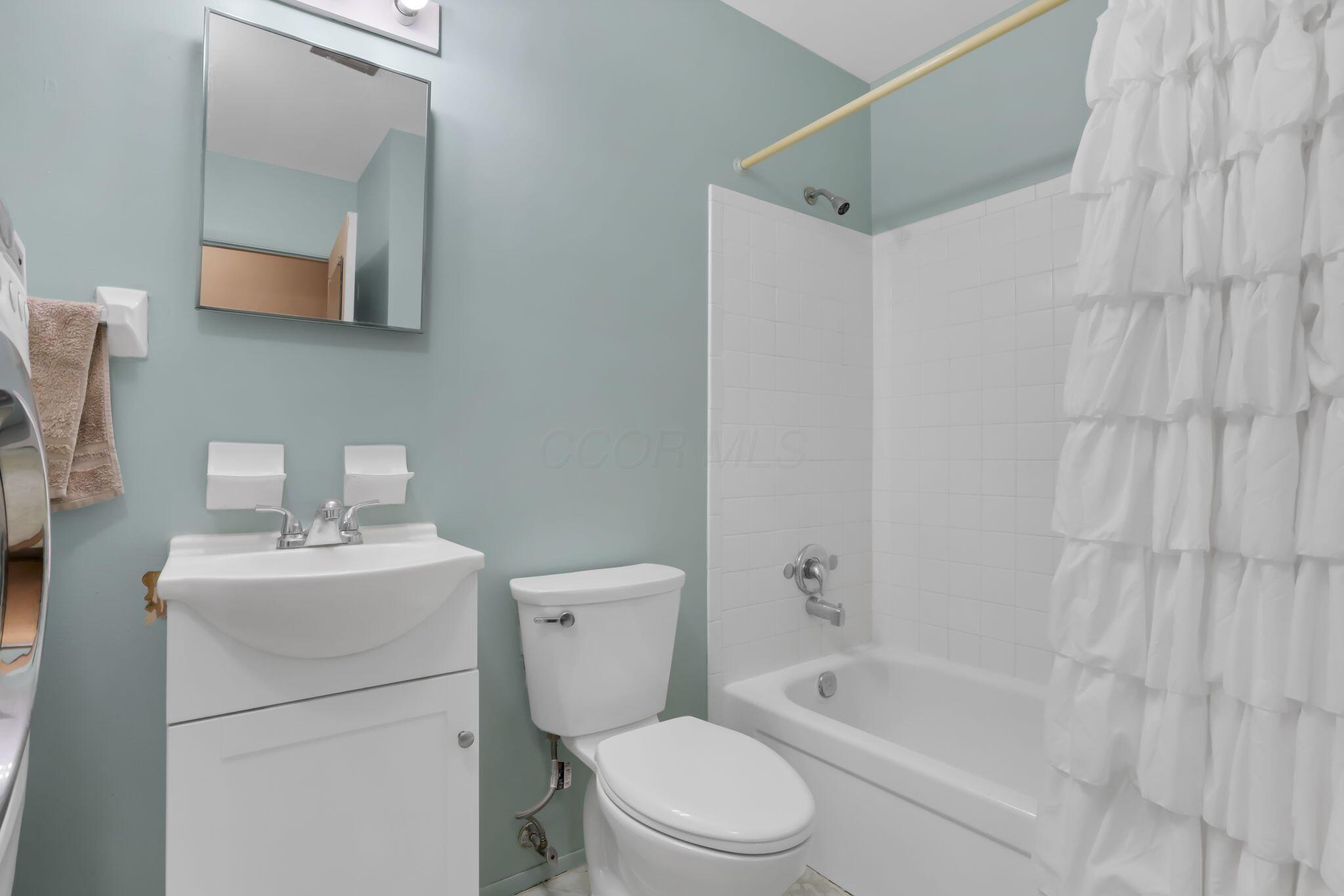 3882 Glenfield Road Columbus, OH 43232 - Photo 15 of 29 Bathroom featuring a white vanity with integrated sink, chrome faucet, and mirrored medicine cabinet