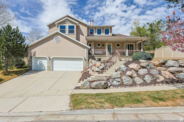11406 Gracey Lane Sandy, UT 84092 - Photo 1 of 1 View of front of house featuring a porch, stucco siding, concrete driveway, and an attached garage
