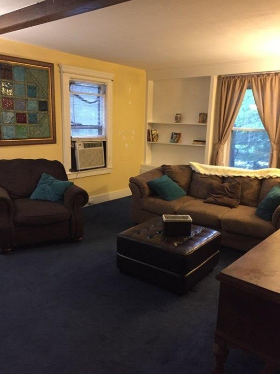 562 Tiffany Street Springfield, MA 01108 - Photo 5 of 7 a living room with furniture and a large window