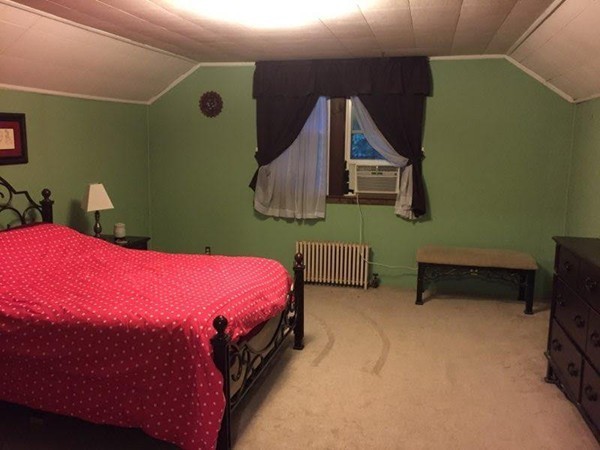 562 Tiffany Street Springfield, MA 01108 - Photo 6 of 7 a bedroom with a bed and a cabinets