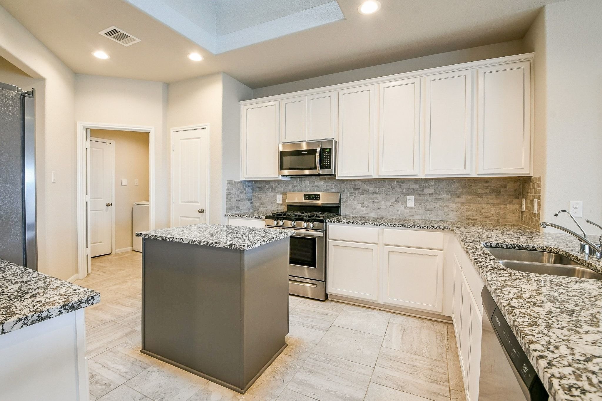 1515 Anyder Place Houston, TX 77047 - Photo 6 of 21 a kitchen with granite countertop a sink and steel appliances
