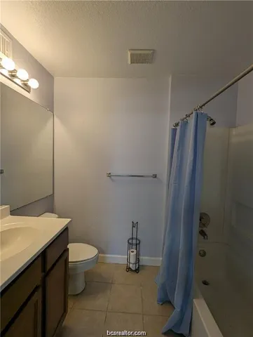 a bathroom with a sink a toilet a mirror and shower