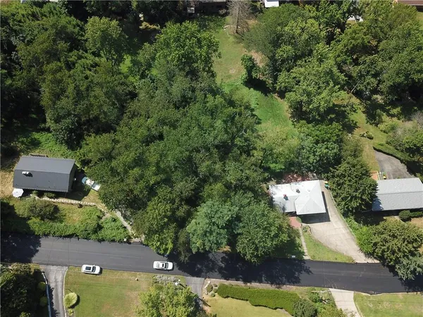 an aerial view of a house with yard swimming pool and outdoor seating