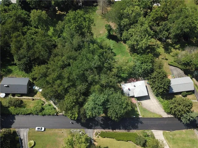 an aerial view of a house with swimming pool outdoor seating and yard