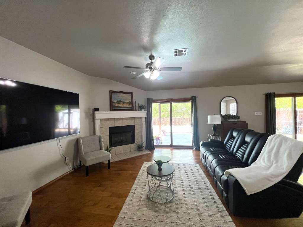 404 Patton Cove Bastrop, TX 78602 - Photo 12 of 40 Living room with ceiling fan, a healthy amount of sunlight, wood finished floors,