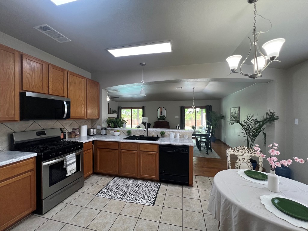 404 Patton Cove Bastrop, TX 78602 - Photo 20 of 40 Kitchen with a new sink, light countertops, a peninsula, appliances with stainless steel finishes