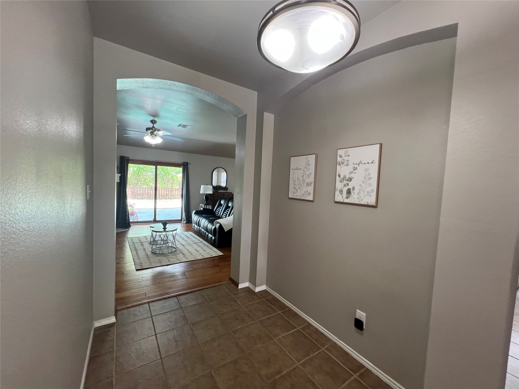 404 Patton Cove Bastrop, TX 78602 - Photo 21 of 40 Hallway featuring arched walkways, ceramic tile patterned floors