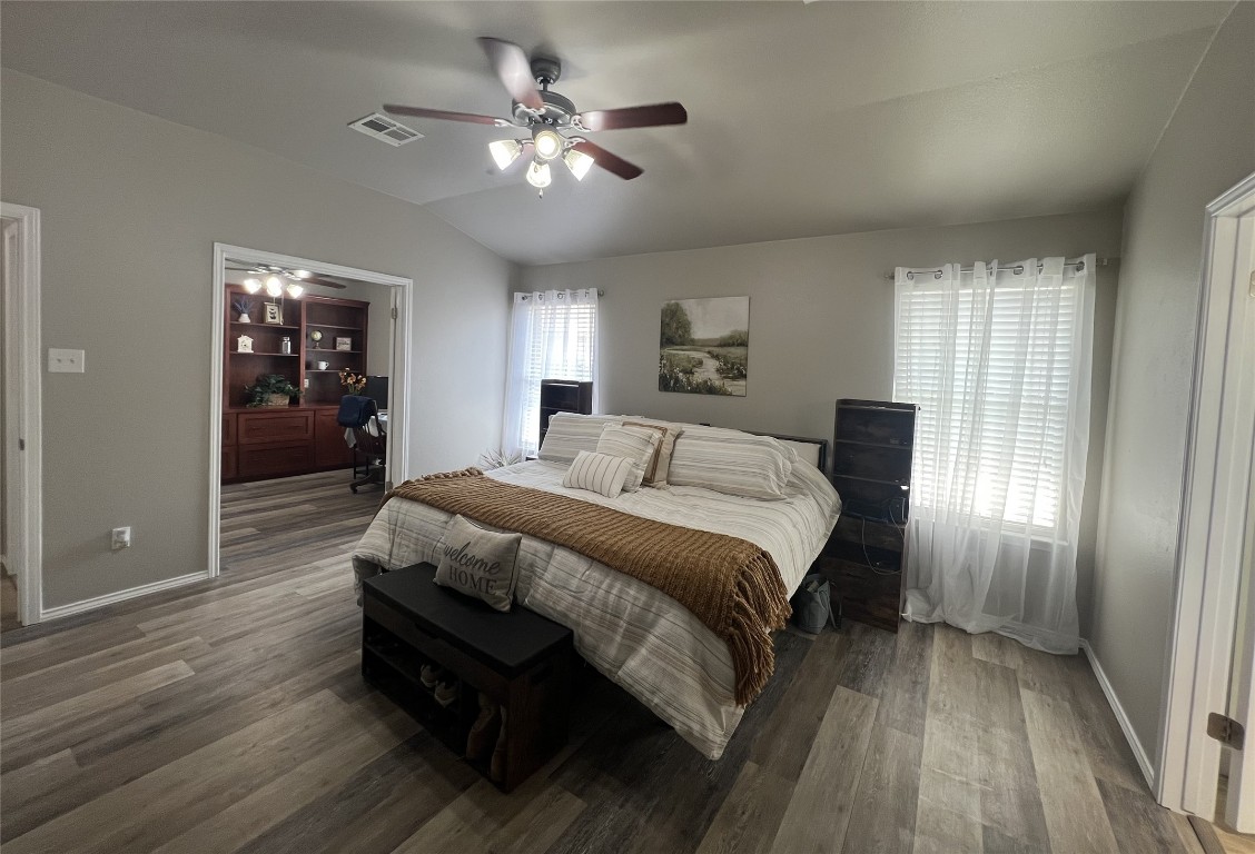 404 Patton Cove Bastrop, TX 78602 - Photo 23 of 40 Bedroom with wood finished floors, vaulted ceiling,