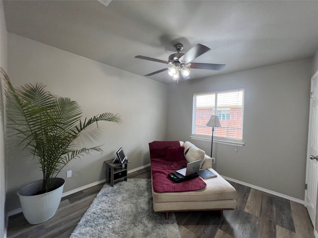 404 Patton Cove Bastrop, TX 78602 - Photo 35 of 40 Bedroom being used as den featuring wood finished floors, a ceiling fan, and baseboards