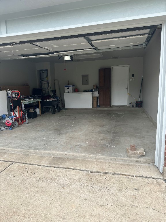 404 Patton Cove Bastrop, TX 78602 - Photo 40 of 40 Garage featuring a garage door opener and electric panel