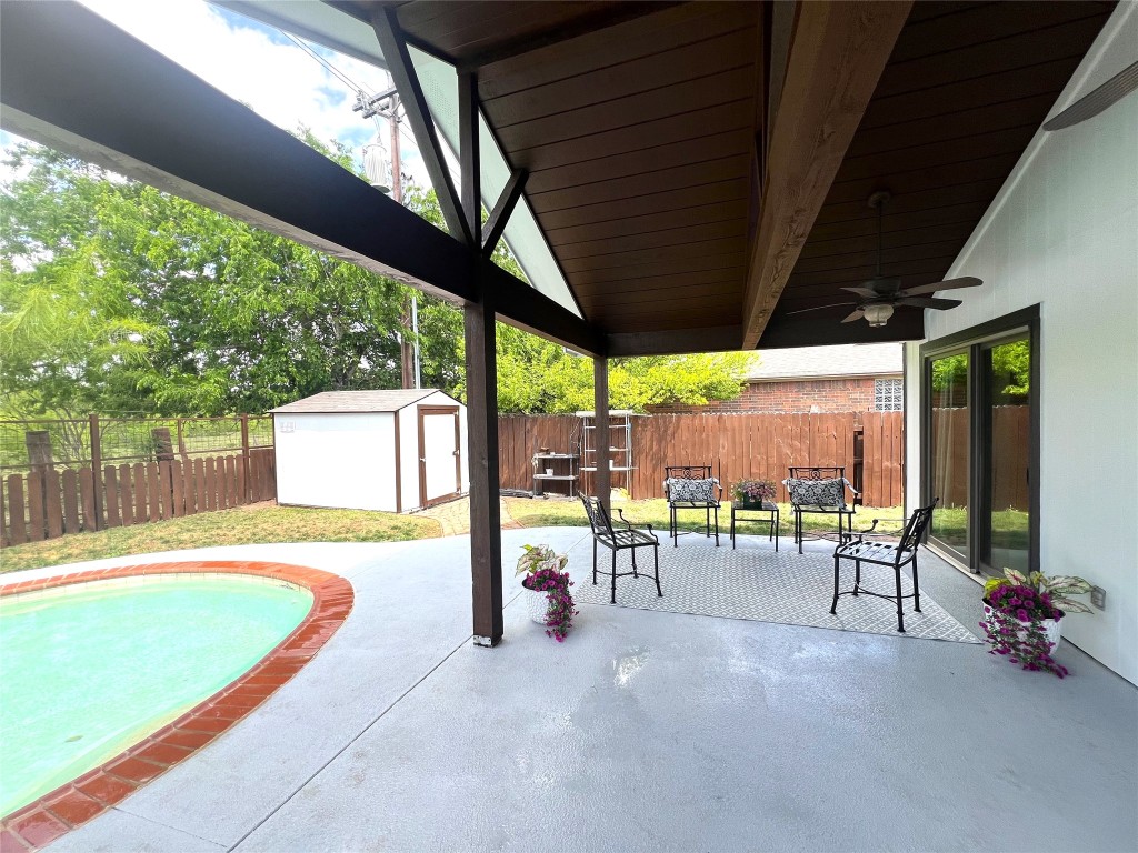 404 Patton Cove Bastrop, TX 78602 - Photo 7 of 40 View of patio with a storage shed, a ceiling fan, an outbuilding, and a fenced backyard