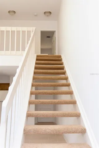 a view of staircase with white walls