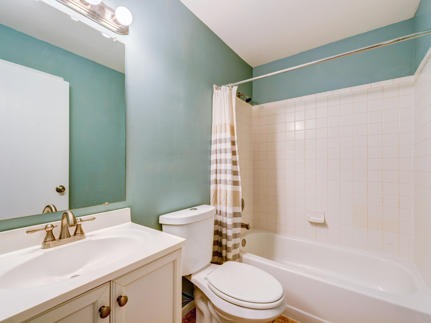 15 Gant Circle, Unit E Streamwood, IL 60107 - Photo 12 of 18 a bathroom with a sink a toilet and shower