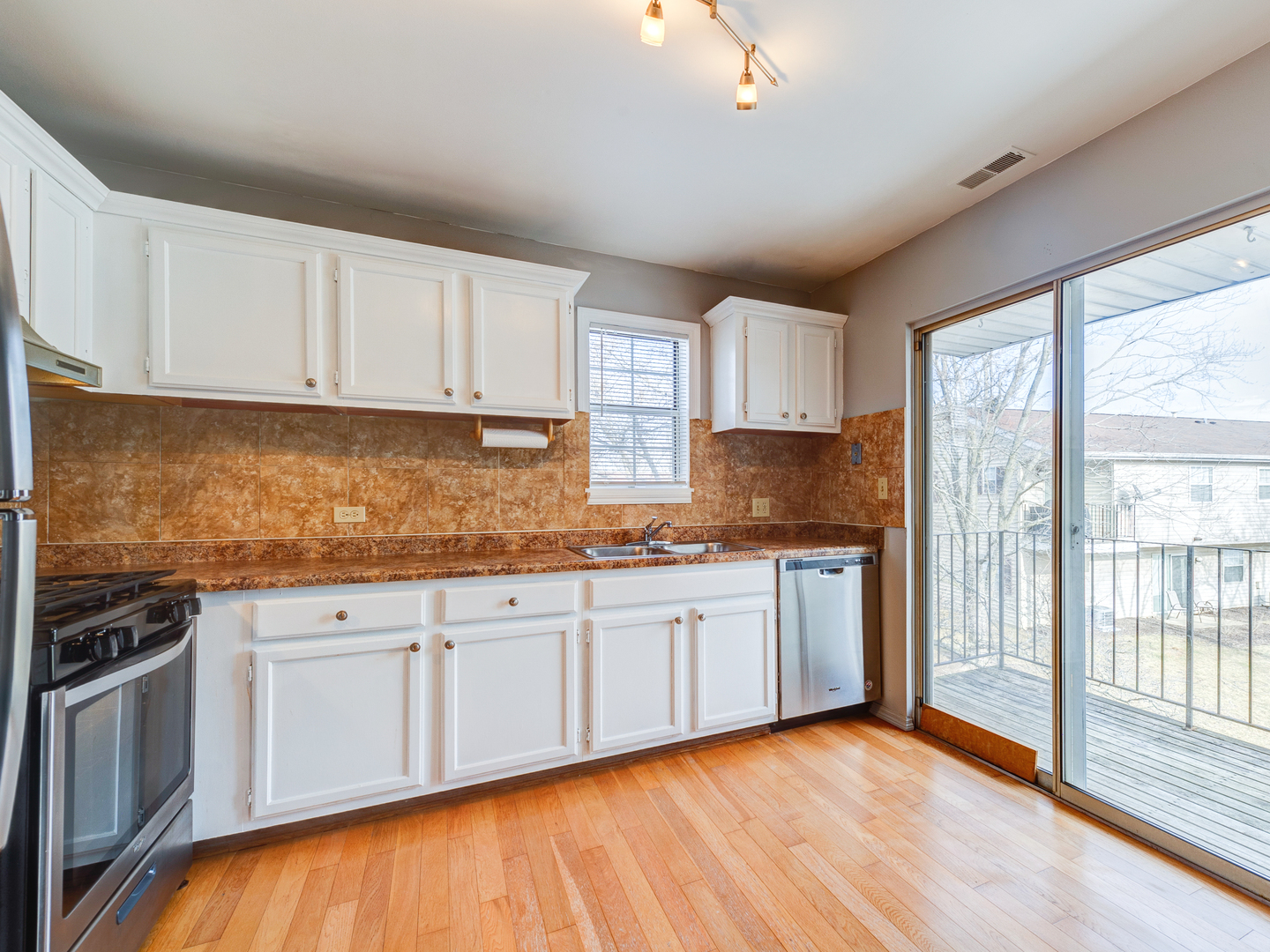 15 Gant Circle, Unit E Streamwood, IL 60107 - Photo 7 of 18 a kitchen with granite countertop a sink stove top oven and cabinets