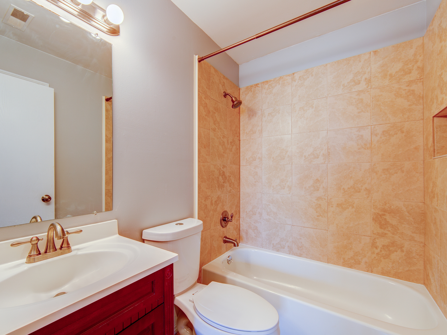 15 Gant Circle, Unit E Streamwood, IL 60107 - Photo 10 of 18 a bathroom with a sink a toilet and a bathtub