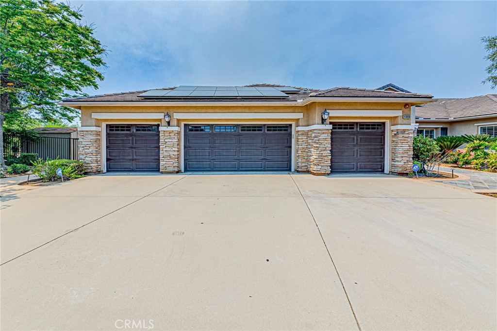 4088 Shady Ridge Circle Corona, CA 92881 - Photo 6 of 47 a view of house with garage and a yard