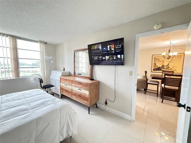 a bedroom with a bed and a chair in it