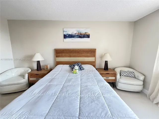 a bedroom with bed and a couch