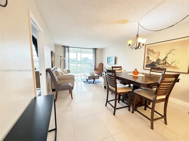 a living room with furniture and large windows