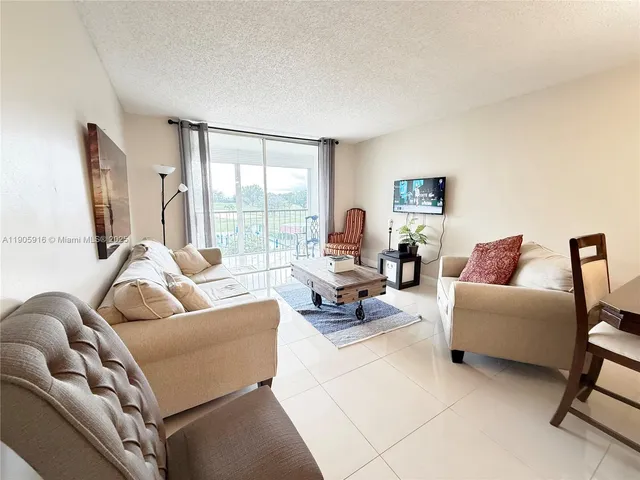 a bedroom with a bed and a chair in it