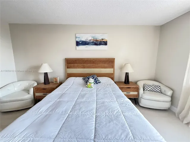 a bedroom with a bed couch and a window