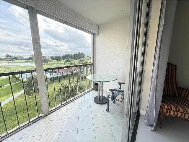 a view of a living room and floor to ceiling window