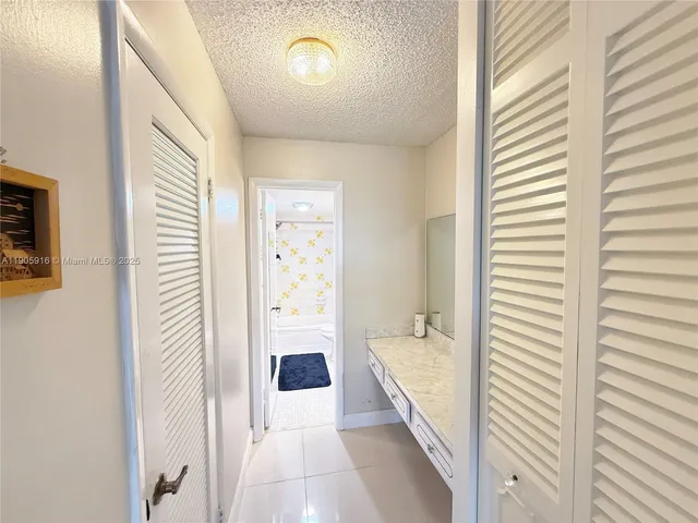 a bathroom with a granite countertop toilet sink and mirror
