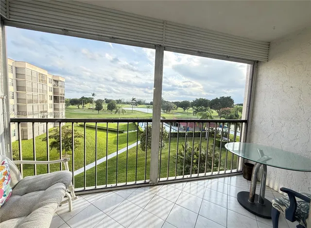 a view of a balcony with chair and wooden floor