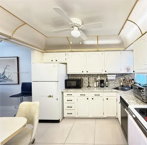 a kitchen with a sink a stove a microwave and refrigerator