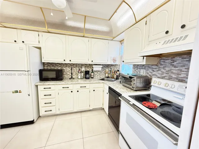 a kitchen with cabinets and appliances