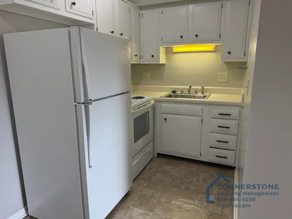 a white refrigerator freezer sitting in a kitchen