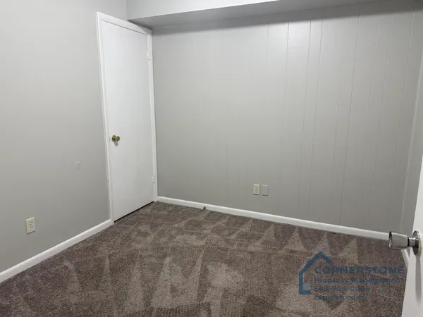 a bathroom with a granite countertop sink and a toilet