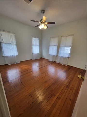 a view of wooden floor and windows in a room
