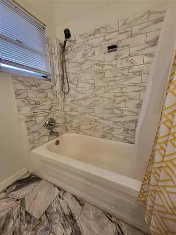 a bathroom with a bath tub