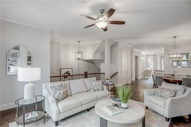 a dining room with wooden floor a chandelier a wooden table and chairs