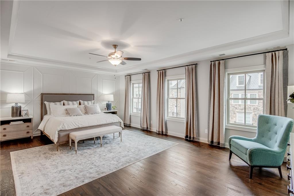 3440 Commander Cove Suwanee, GA 30024 - Photo 29 of 59 a spacious bedroom with a bed a couch and a large window