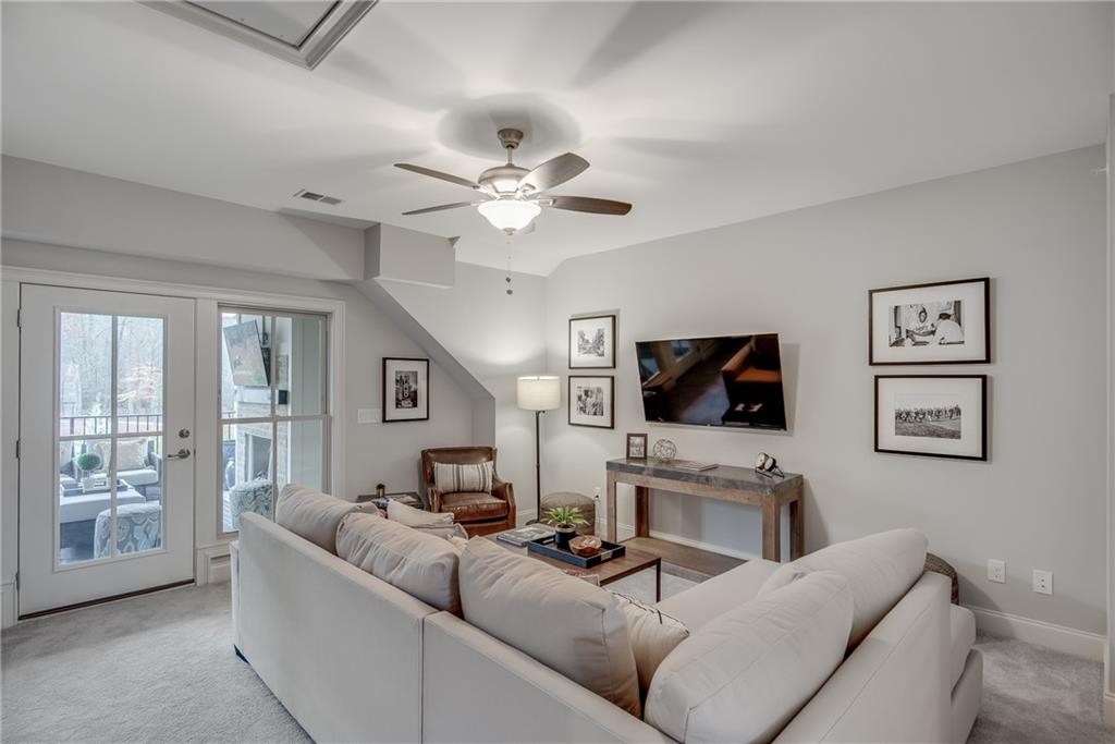3440 Commander Cove Suwanee, GA 30024 - Photo 37 of 59 a living room with furniture and a flat screen tv