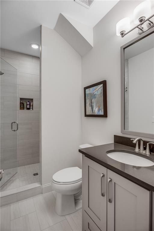 3440 Commander Cove Suwanee, GA 30024 - Photo 42 of 59 a bathroom with a granite countertop toilet sink and shower