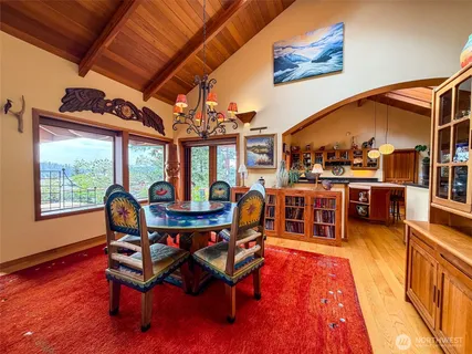 a living room with furniture a wooden floor and next to a window